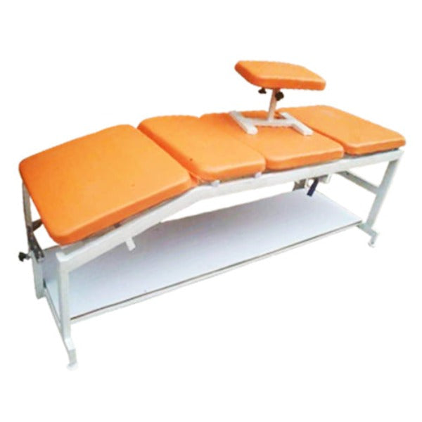 Massage table with orange cushions on a white background