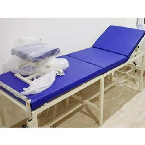 Medical examination table with blue surface and metal frame on a white background