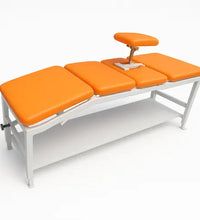 Massage table with orange cushions on a white background