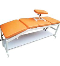 Orange massage table with white base on a white background