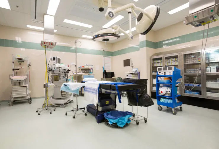 Empty operating room with medical equipment and supplies.