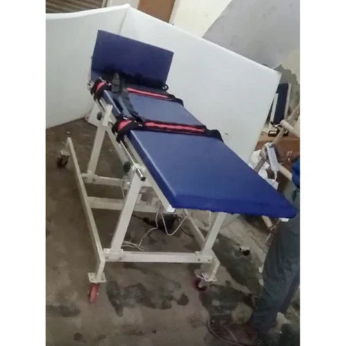 Blue medical examination table with straps on a white background