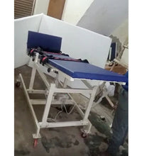 Blue and white medical examination table in a room with a window.