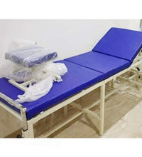 Blue examination table with medical supplies in a room.